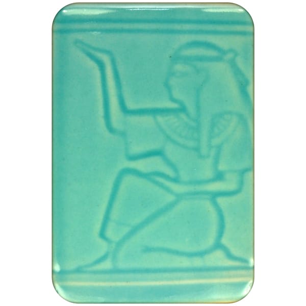 White clay tile featuring an imprint of a kneeling pharoah glazed with Spectrum 1463 Cerulean Semi-Transparent Glazepooled into the indentations.