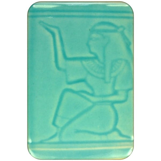 White clay tile featuring an imprint of a kneeling pharoah glazed with Spectrum 1463 Cerulean Semi-Transparent Glazepooled into the indentations.