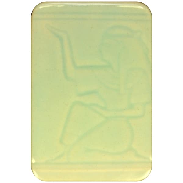 White clay tile featuring an imprint of a kneeling pharoah glazed with Spectrum 1465 Light Celadon Semi-Transparent Glazepooled into the indentations