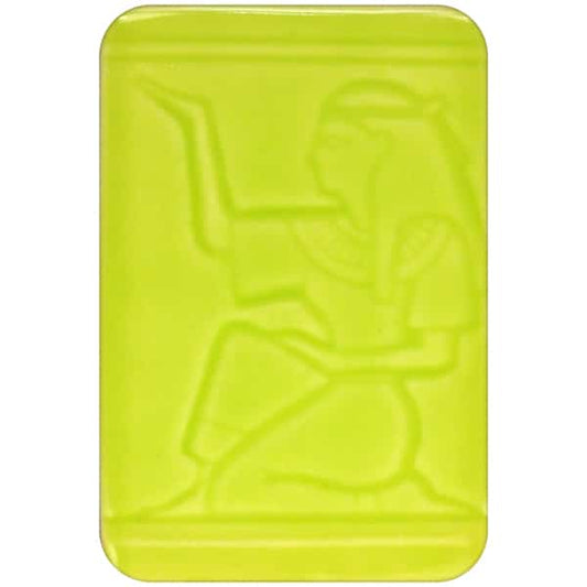 White clay tile featuring an imprint of a kneeling pharoah glazed with Spectrum 1467 Spring Green Semi-Transparent Glazepooled into the indentations