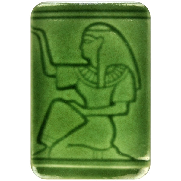 White clay tile featuring an imprint of a kneeling pharoah glazed with Spectrum 1468 Bottle Green Semi-Transparent Glazepooled into the indentations