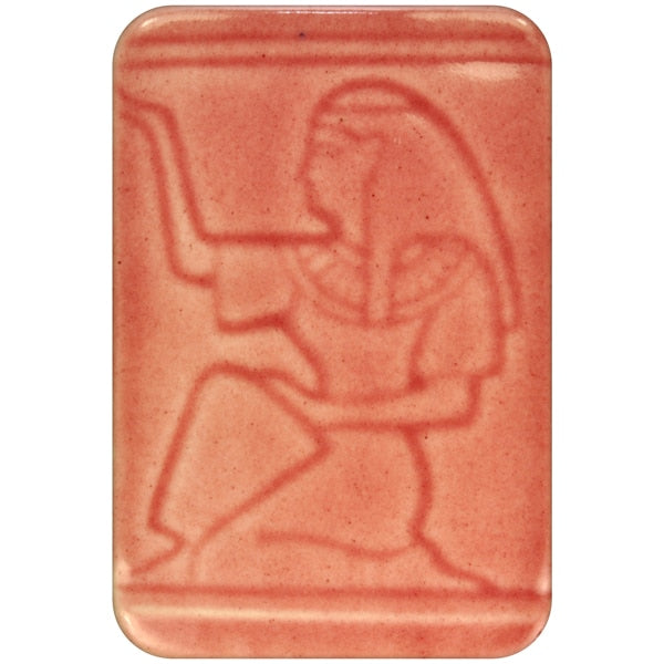 White clay tile featuring an imprint of a kneeling pharoah glazed with Spectrum 1470 Cranberry Semi-Transparent Glazepooled into the indentations