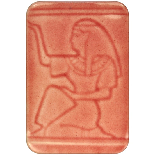 White clay tile featuring an imprint of a kneeling pharoah glazed with Spectrum 1470 Cranberry Semi-Transparent Glazepooled into the indentations