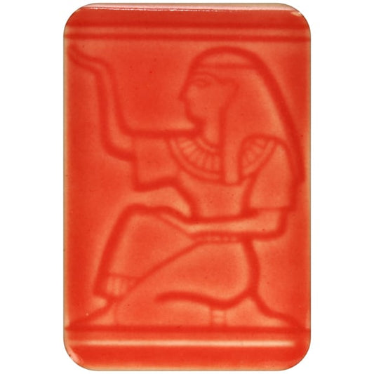 White clay tile featuring an imprint of a kneeling pharoah glazed with Spectrum 1472 Watermelon Semi-Transparent Glazepooled into the indentations
